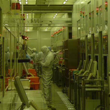 Teams of engineers adjusting systems at the CVD process bay but only one green lamp is on, indicating a system is operating. (At the 200mm line in the Naka clean room)